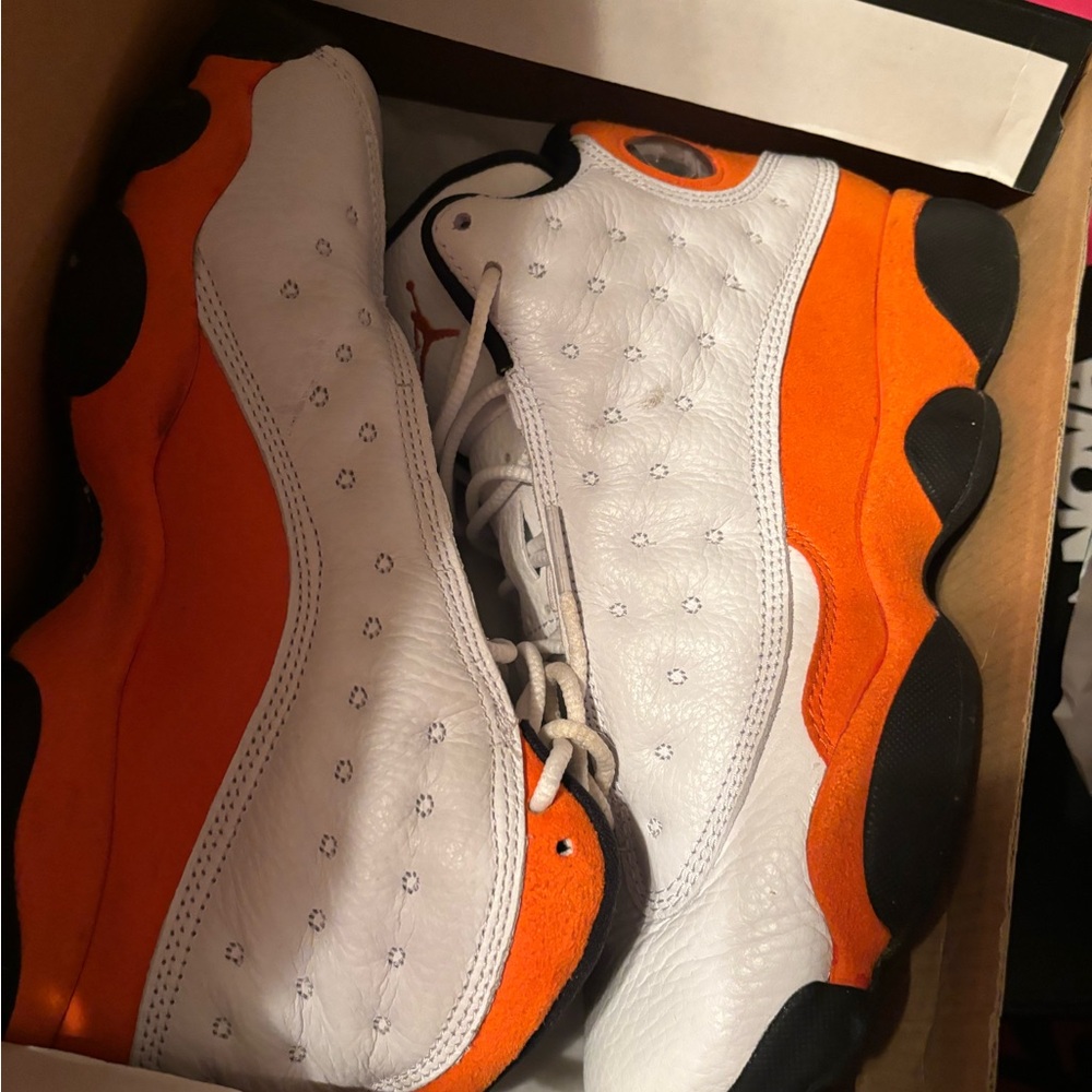 Orange and white Jordan 13’s